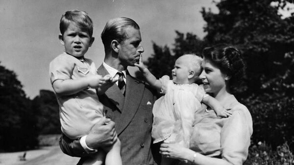 Британская королева Елизавета II, в то время принцесса Елизавета, стоит со своим мужем принцем Филиппом, герцогом Эдинбургским, и их детьми 