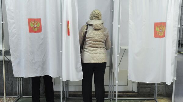 Voters cast their votes in the governor's election held at ballot box 686 in Tambov