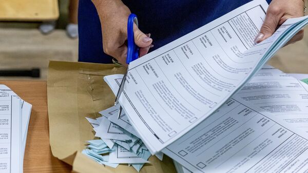 An election official in Vladivostok destroys unused ballot papers after the voting is over.  On September 11, elections to the City Duma were held in Vladivostok.