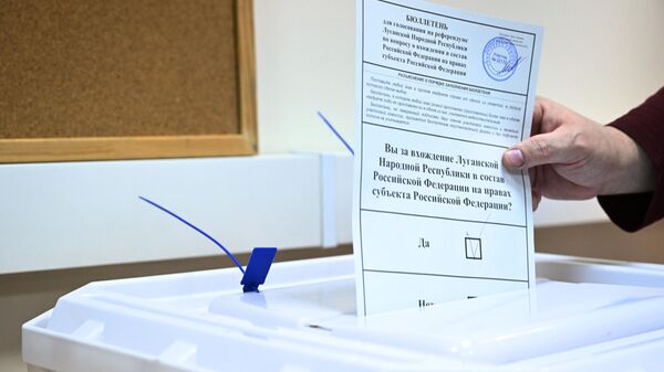 A man votes in a referendum on the accession of the Luhansk People's Republic to Russia at a ballot box at the DPR embassy in Moscow