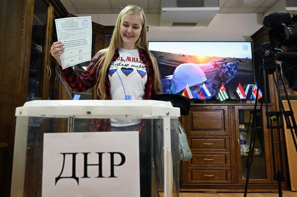 Девушка голосует на референдуме о присоединении Донецкой народной республики к России на избирательном участке в посольстве ДНР в Москве