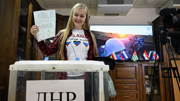 A girl votes in a referendum on the accession of the Donetsk People's Republic to Russia at a ballot box at the DPR embassy in Moscow