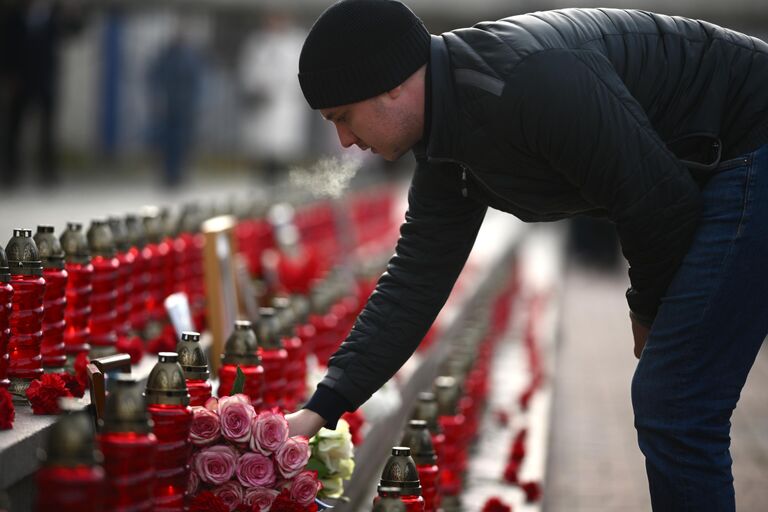 Мужчина возлагает цветы на мероприятии, посвященном 20-й годовщине со дня трагических событий захвата террористами мирных людей на мюзикле Норд-Ост в Театральном центре на Дубровке