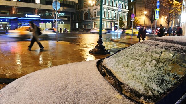 Снег на капоте автомобиля в Москве