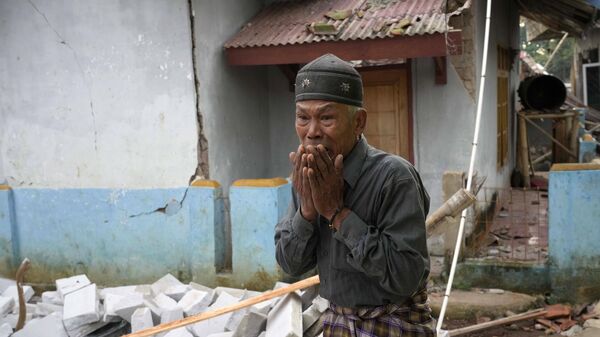 A man at the devastation site of an earthquake in West Java, Indonesia