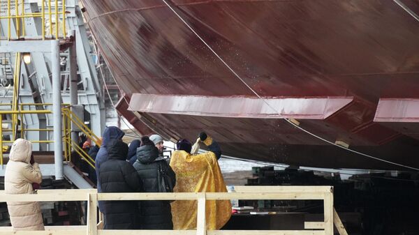 Священнослужитель освящает корпус атомного ледокол Якутия проекта 22220 перед его спуском на воду на Балтийском заводе в Санкт-Петербурге