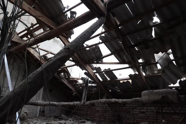 Разрушенная крыша жилого дома в Ворошиловском районе Донецка после обстрелов со стороны ВСУ
