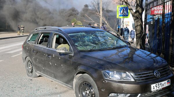 Посеченный осколками автомобиль после обстрела украинскими войсками центрального Ворошиловского района Донецка