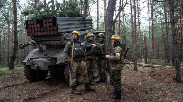 Украинские военные возле реактивной системы залпового огня БМ-21 Град на линии соприкосновения
