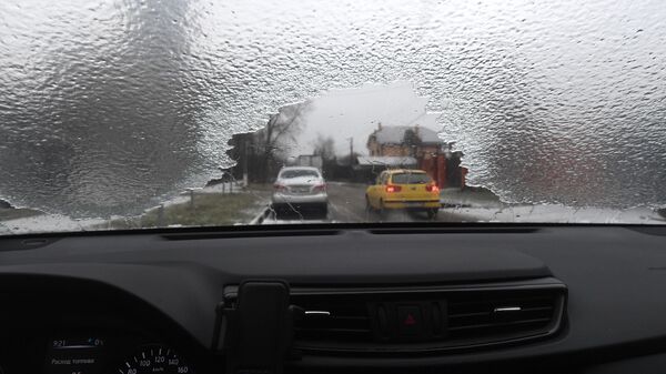 Вид на дорогу через лобовое стекло автомобиля после прошедшего ледяного дождя