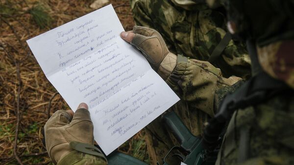 Военнослужащий читает письмо на боевой позиции