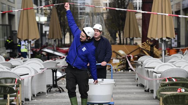 Спасатели выносят рыб, выживших после инцидента с лопнувшим аквариумом в Берлине