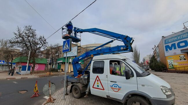 Сотрудник коммунального предприятия осматривает провода