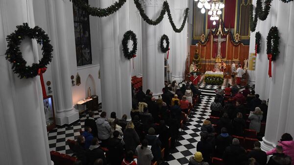 Участники празднования католического Рождества в католической церкви пресвятой Богородицы во Владивостоке