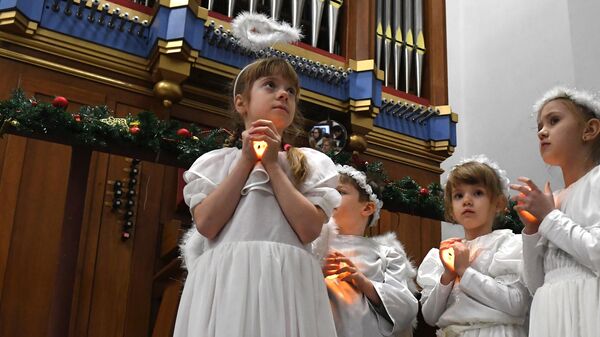 Дети в костюмах ангелов на праздновании католического Рождества в католической церкви Пресвятой Богородицы во Владивостоке