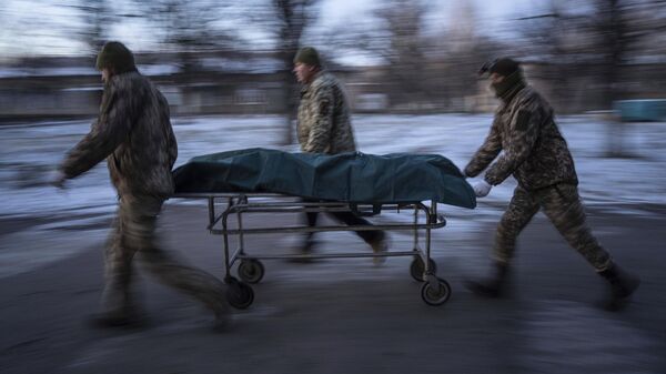 Украинские военнослужащие перевозят носилки с погибшим в Донецкой области