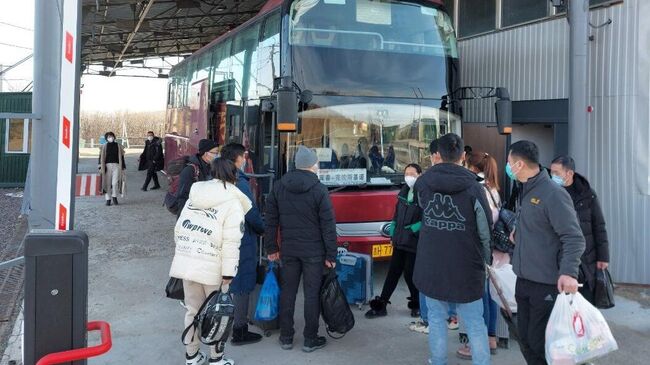 Пассажиры садятся в автобус в пункте пропуска МАПП Краскино в Приморском крае