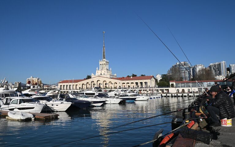 Рыбаки на пирсе и морской вокзал в Центральном районе города Сочи