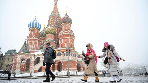 Туристы из Китая гуляют на Красной площади в Москве