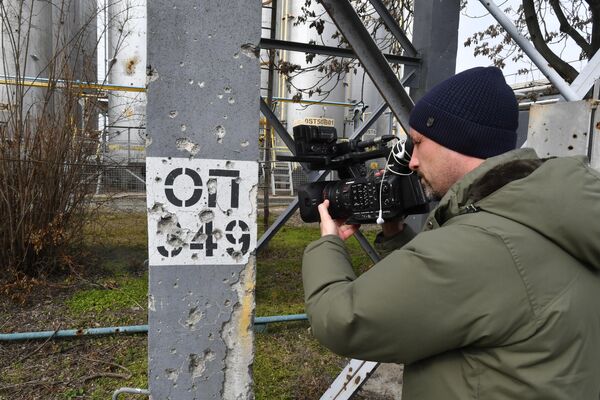 Журналист снимает на видеокамеру повреждения от обстрелов на территории Запорожской АЭС в Энергодаре