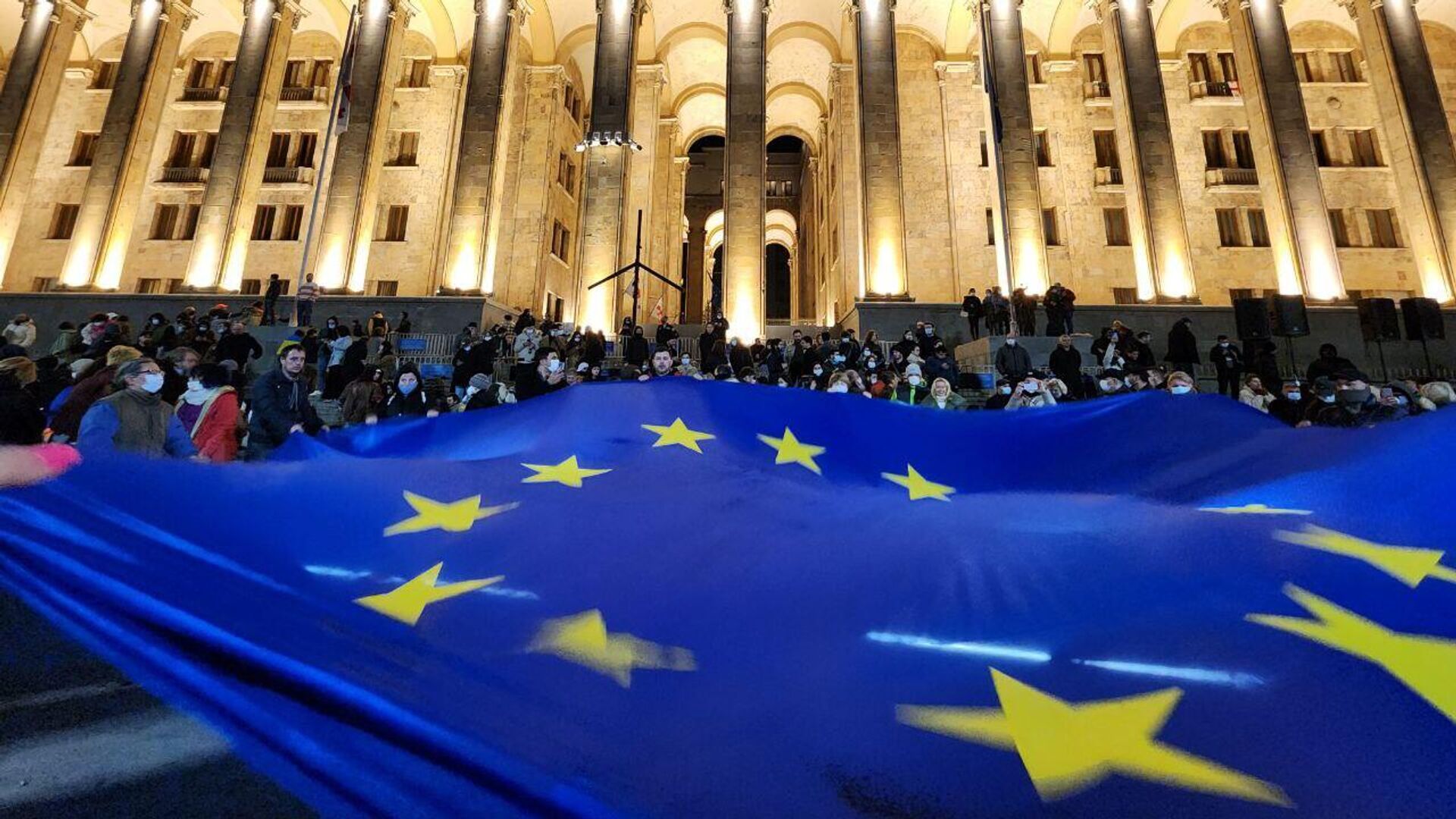 Участники акции разворачивают флаг Евросоюза у здания парламента Грузии в центре Тбилиси - РИА Новости, 1920, 26.01.2024