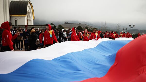 Participants of the action dedicated to the Day of the reunification of Crimea with Russia, on the square near the Cathedral of St. Andrew the First in Gelendzhik