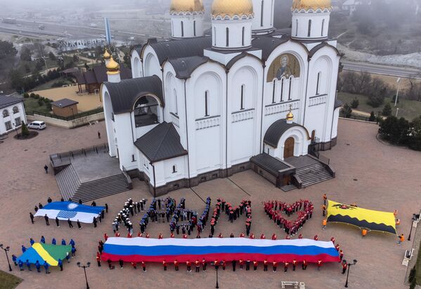 Участники акции, посвященной Дню воссоединения Крыма с Россией, на площади у Собора Андрея Первозданного в Геленджике