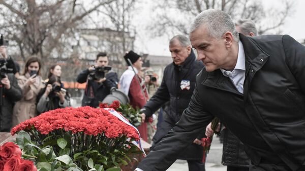 Crimean leader Sergei Aksyonov lays flowers at the All-Time People's Militia monument in Simferopol