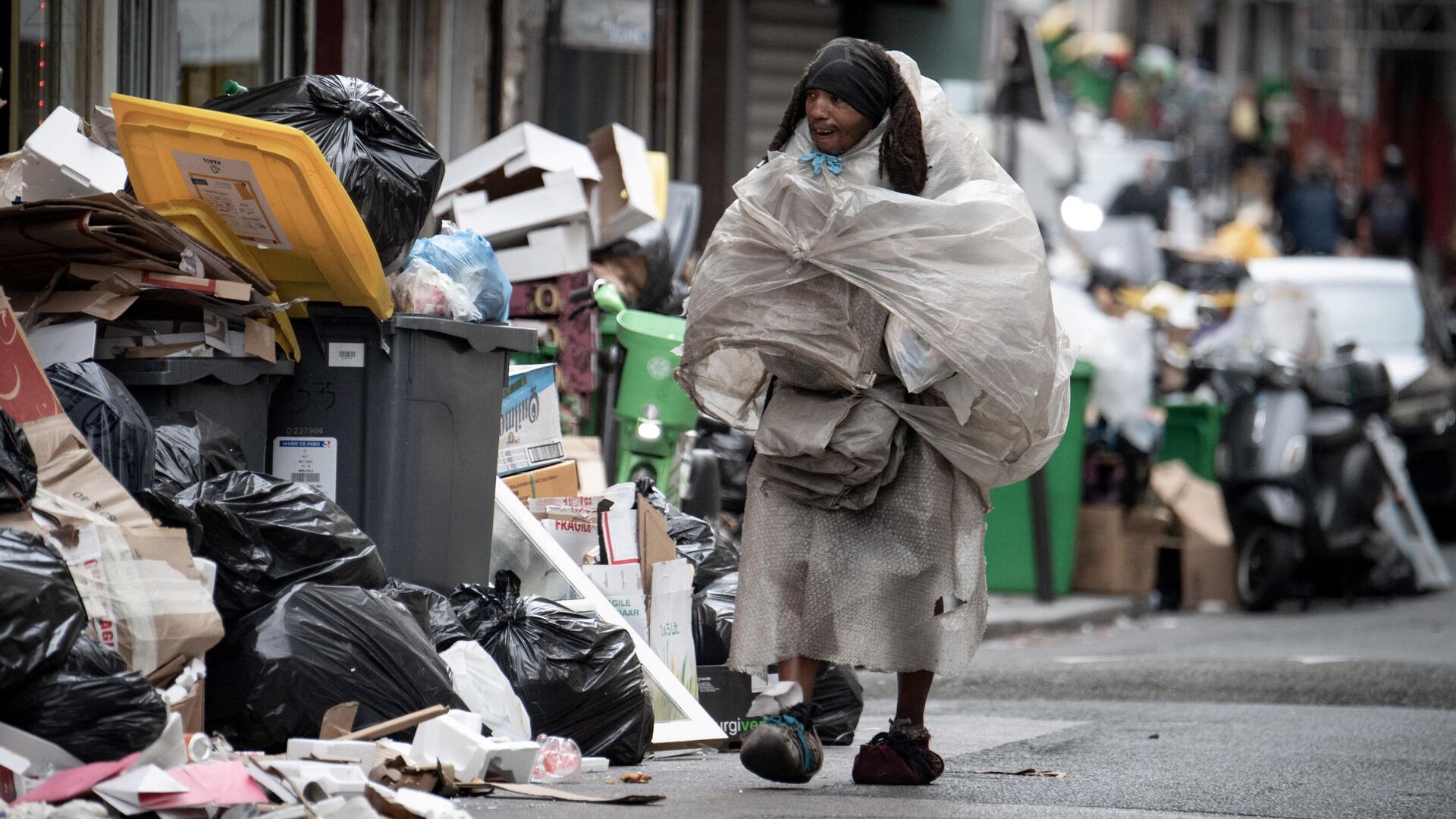 Бездомный на улице, заваленной мусором после акция протеста, в Париже - РИА Новости, 1920, 28.03.2023