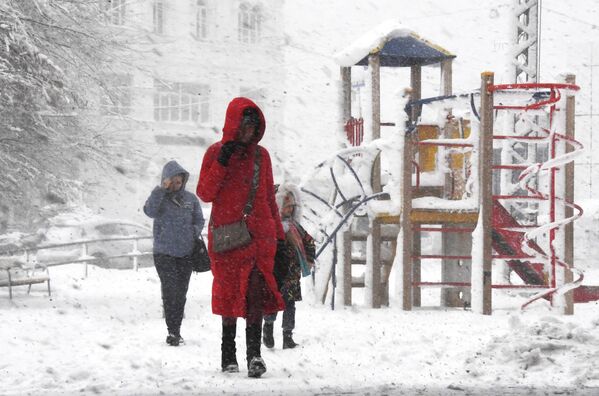 Люди во время снегопада во Владивостоке