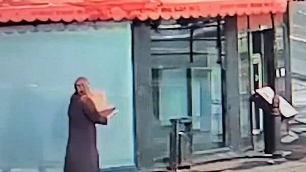 Девушка вносит коробку в здание перед взрывом. Видео с камеры наблюдения