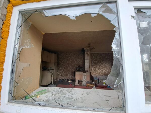 Окно жилого дома, разбитое в результате обстрела со стороны ВСУ в поселке Нижняя Крынка в Советском районе Донецкой народной республики