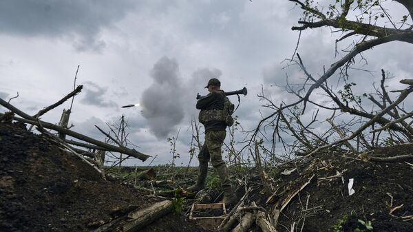 Украинский военнослужащий стреляет из гранатомета по российским позициям