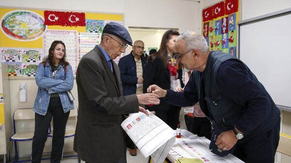 A man takes the ballot papers at a ballot box in Ankara.