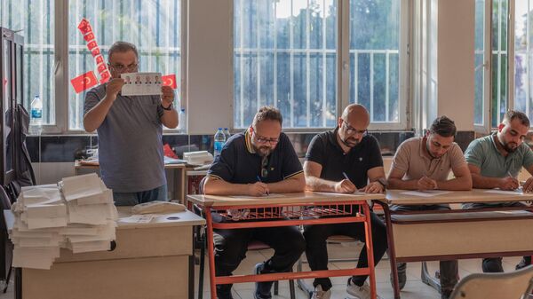 Сотрудники избирательной комиссии подсчитывают бюллетени на избирательном участке в Антакье