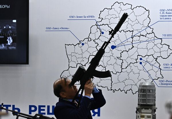 Посетитель с оружием на 11-й международной выставке вооружения и военной техники MILEX-2023 в Минске