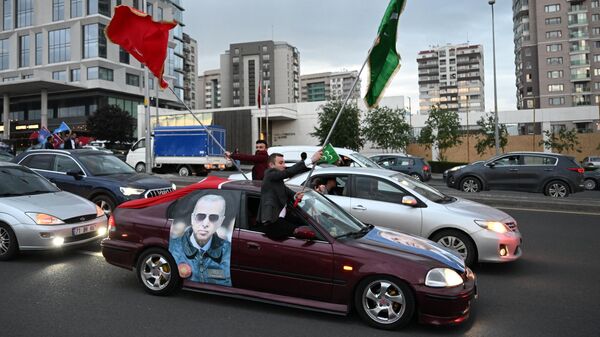 Сторонники действующего президента Реджепа Тайипа Эрдогана у президентского дворца в Анкаре радуются предварительным итогам второго тура президентских выборов в Турции