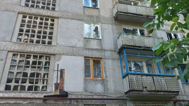 Последствия попадания снаряда ВСУ во двор многоэтажного дома в Горловке