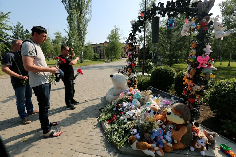 Люди несут цветы к мемориалу в память о детях, погибших из-за обстрелов Донбасса вооруженными силами Украины, на Аллее ангелов в парке Ленинского Комсомола в Донецке