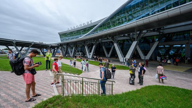 Пассажиры у здания аэропорта им. А.П. Чехова в Южно-Сахалинске