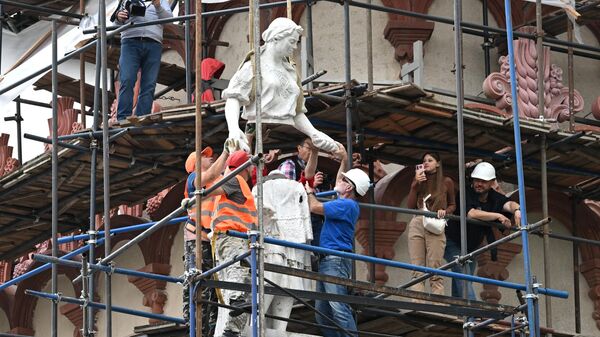 Скульптуры Колхозница со снопом и Рабочий с разводным ключом устанавливают после реставрации на крышу павильона Центросоюз на ВДНХ