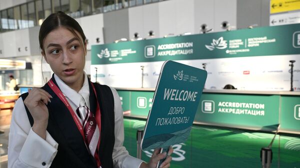 Девушка встречает участников Восточного экономического форума в аэропорту Кневичи во Владивостоке
