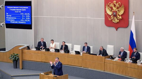 Руководитель фракции ЛДПР в Госдуме Леонид Слуцкий аплодирует после объявления итогов голосования на пленарном заседании Государственной думы