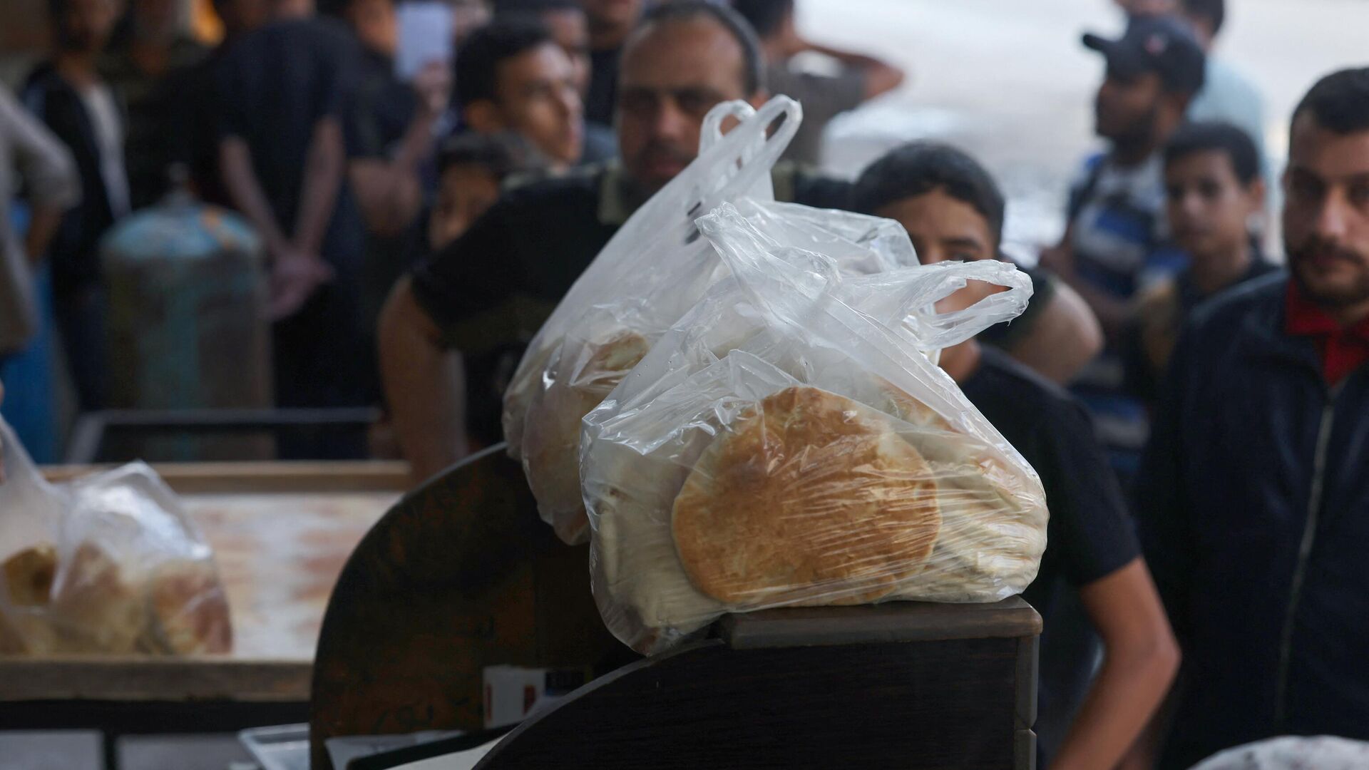 Палестинцы стоят в очереди за хлебом в пекарне в Рафахе на юге сектора Газа - РИА Новости, 1920, 21.10.2023