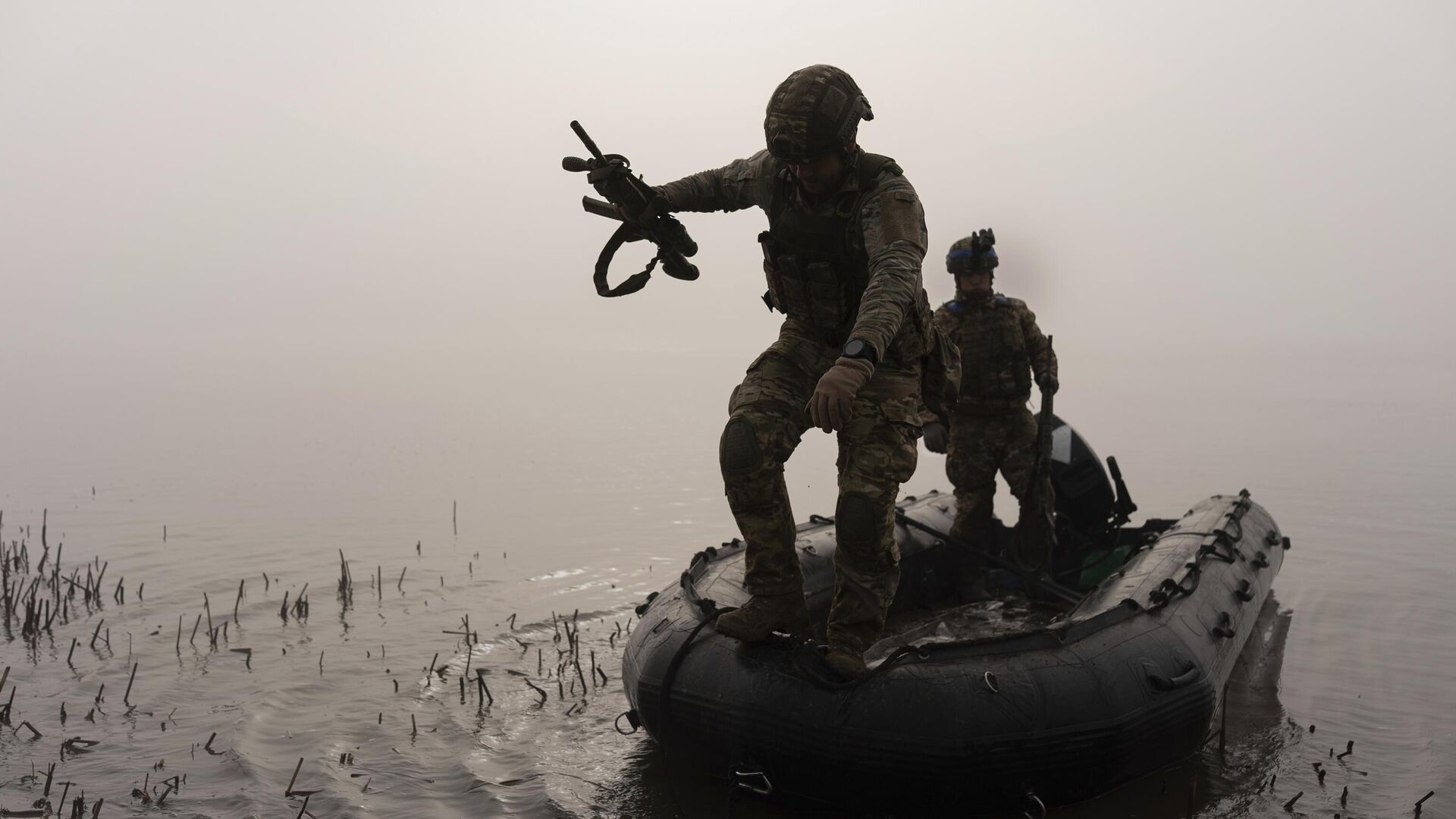 Украинский военнослужащий выпрыгивает из лодки на берег Днепра под Херсоном - РИА Новости, 1920, 23.08.2024