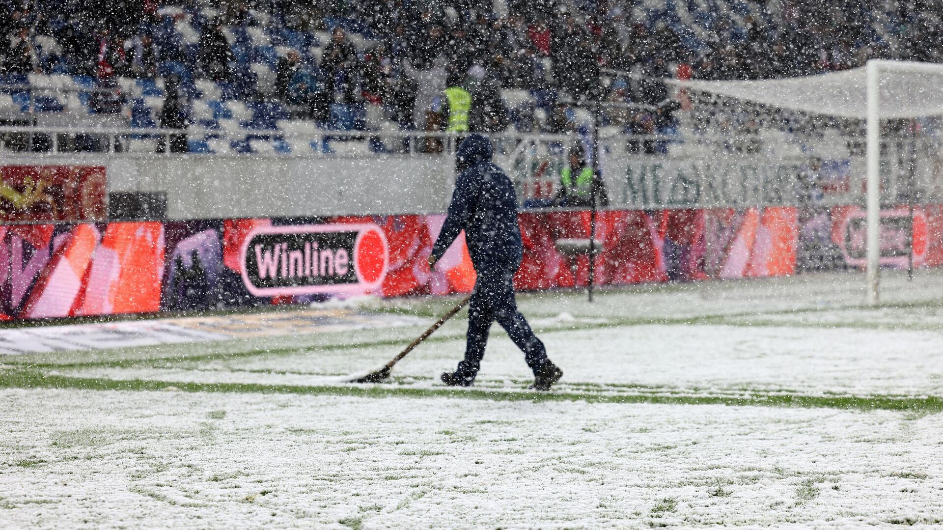 Сотрудник стадиона очищает поле от снега - РИА Новости, 1920, 03.12.2023