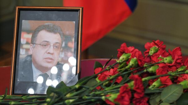 Цветы у портрета посла России в Турции Андрея Карлова