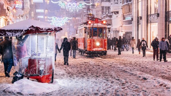 Продавец жареных каштанов на улице Истикляль в Стамбуле
