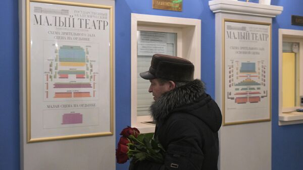 Мужчина с цветами в память о художественном руководителе Малого театра Юрии Соломине