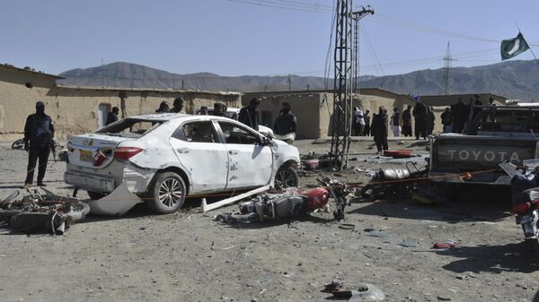 Сотрудники службы безопасности осматривают место взрыва в провинции Белуджистан на юго-западе Пакистана
